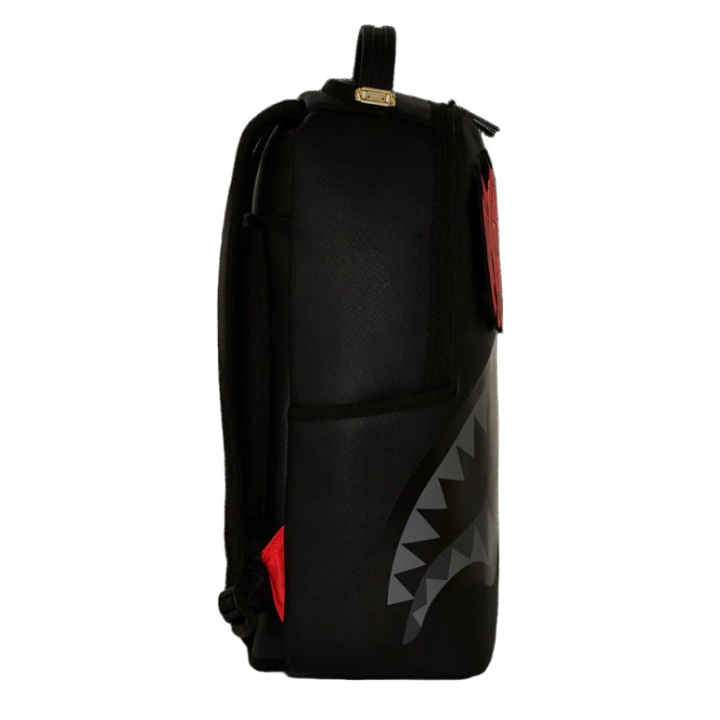 Black backpack with shark mouth design on a white background