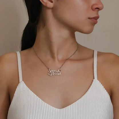 Woman wearing a necklace with 'Seraphina' pendant against a neutral background