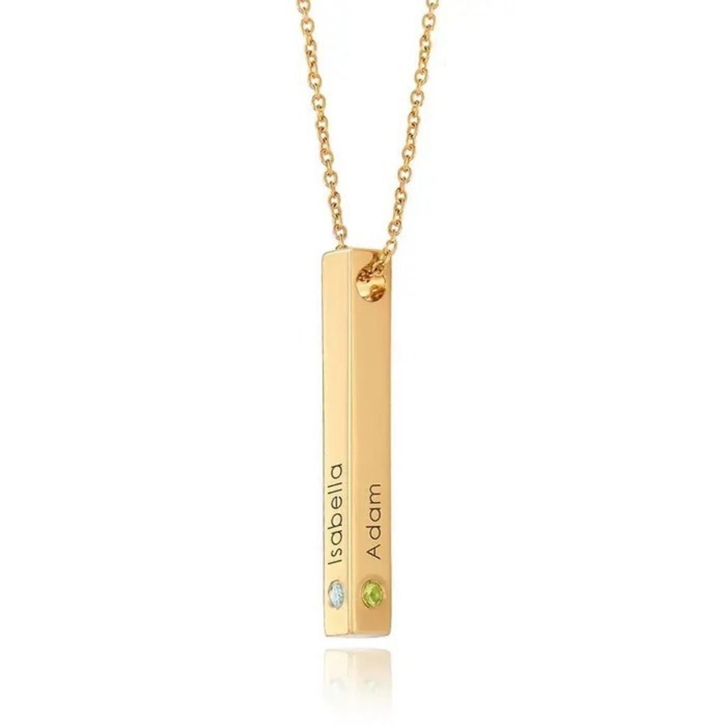 Gold necklace with a bar pendant featuring engraved names on a white background