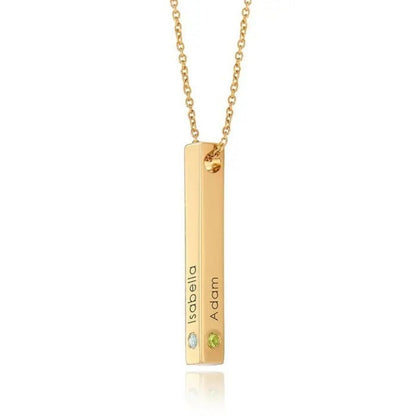 Gold necklace with a bar pendant featuring engraved names on a white background