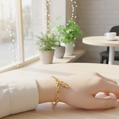 Gold bracelet on a wrist with a blurred indoor background