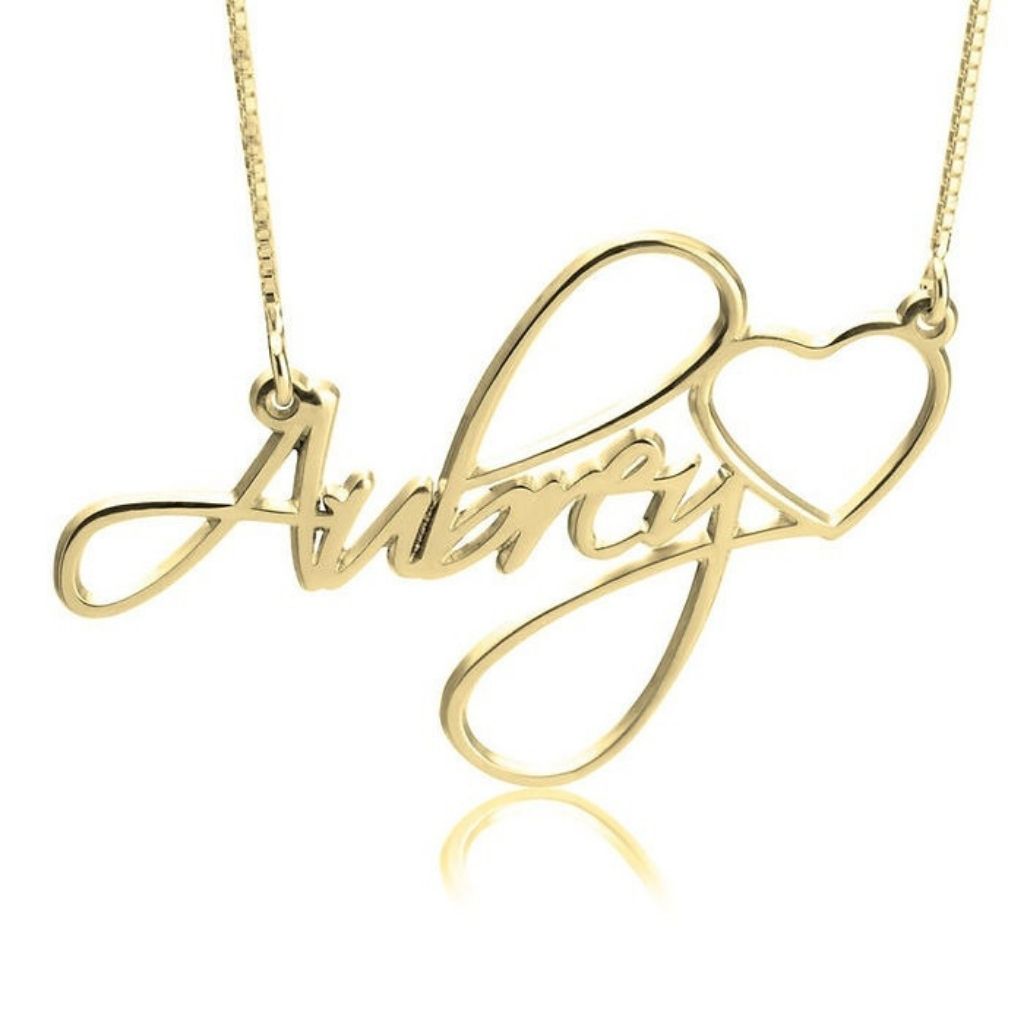 Gold necklace with 'Amore' and heart design on a white background