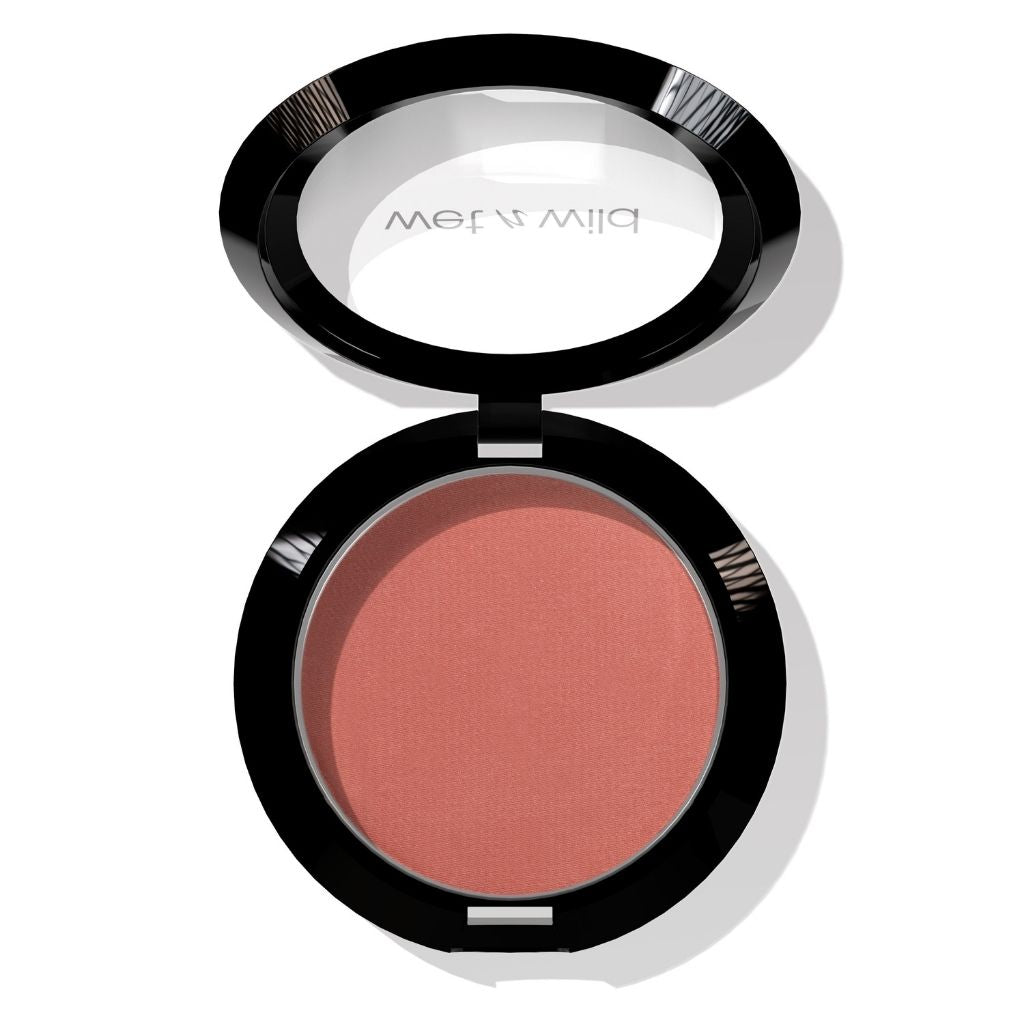 Open makeup compact with blush color on a white background