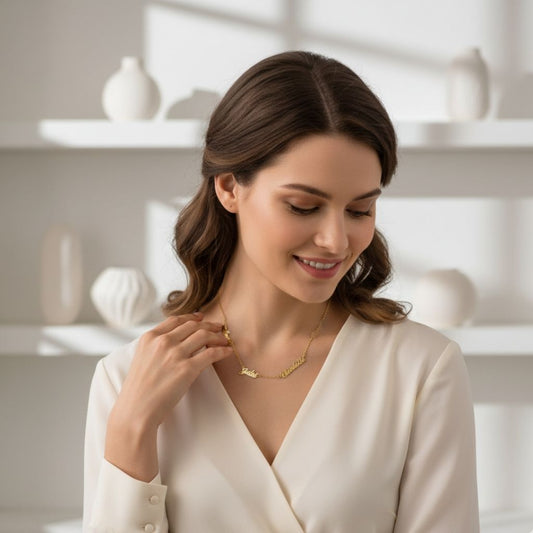 Woman wearing a gold necklace in a bright room with white shelves.