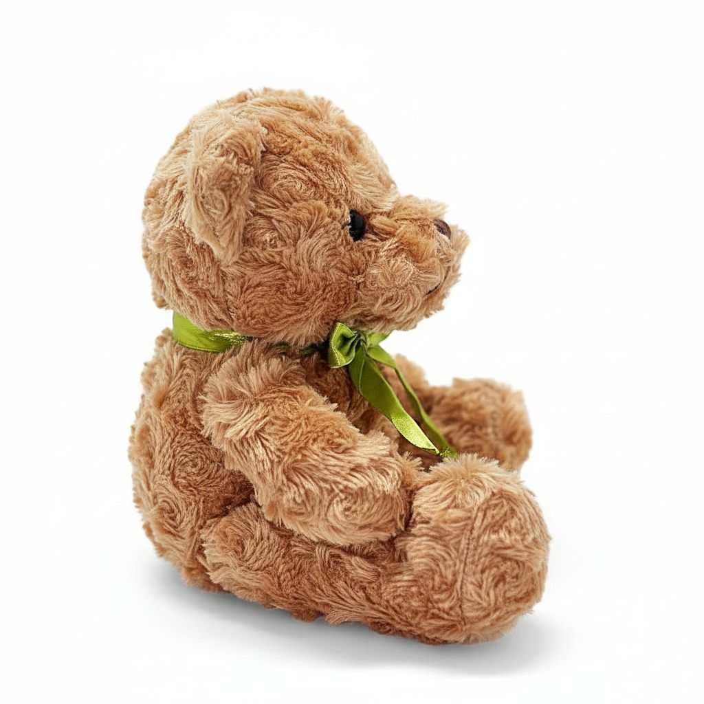 Brown teddy bear with a green bow on a white background