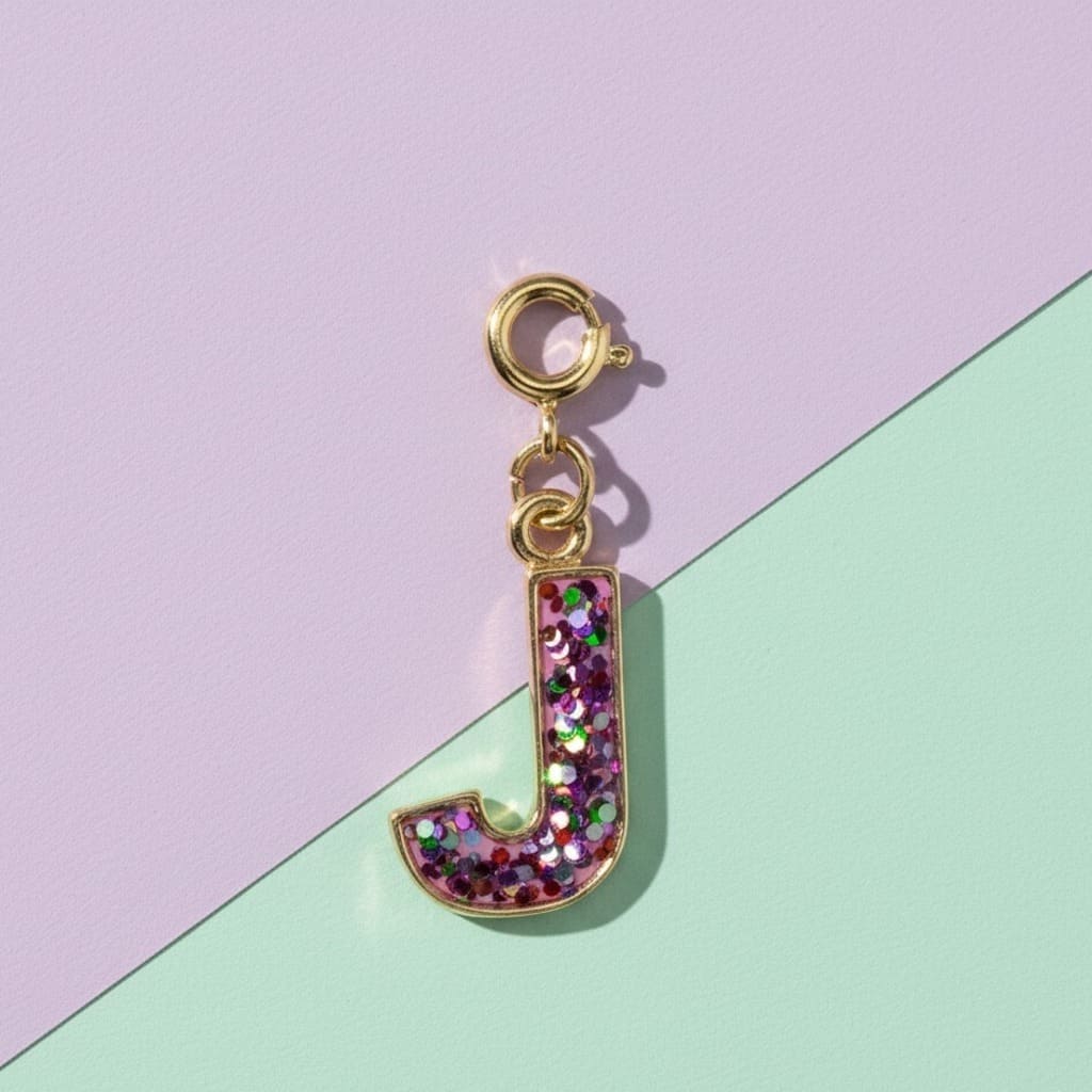 Glittery letter 'J' charm on a pastel background