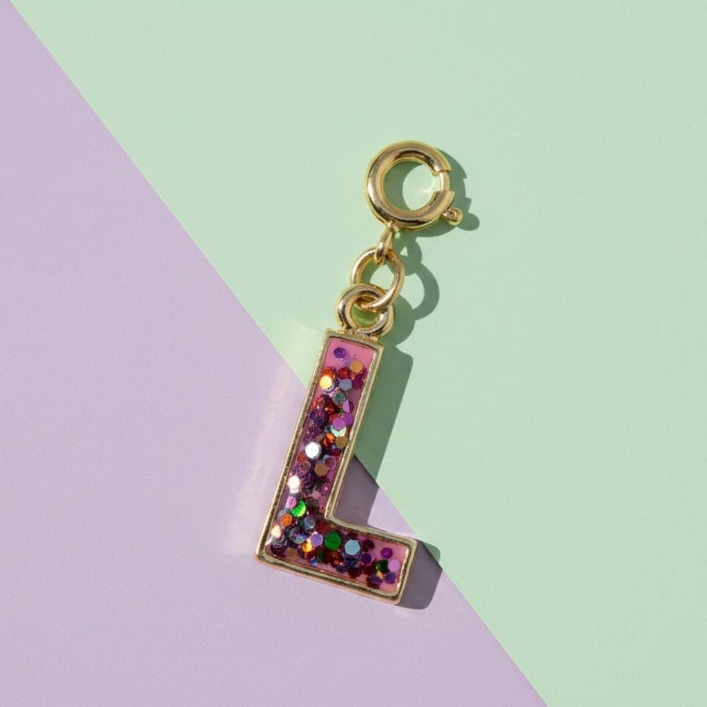 Gold charm with letter 'L' made of colorful glittery beads on a two-tone background