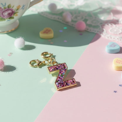 Decorative letter 'Z' charm with colorful stones on a pastel background