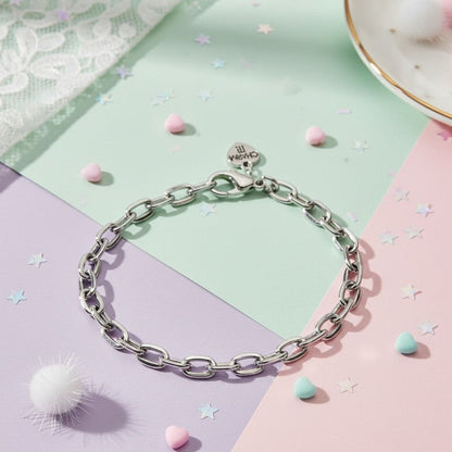 Silver chain bracelet on a colorful background with decorative elements