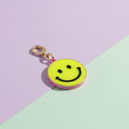 Smiley face charm on a pastel background