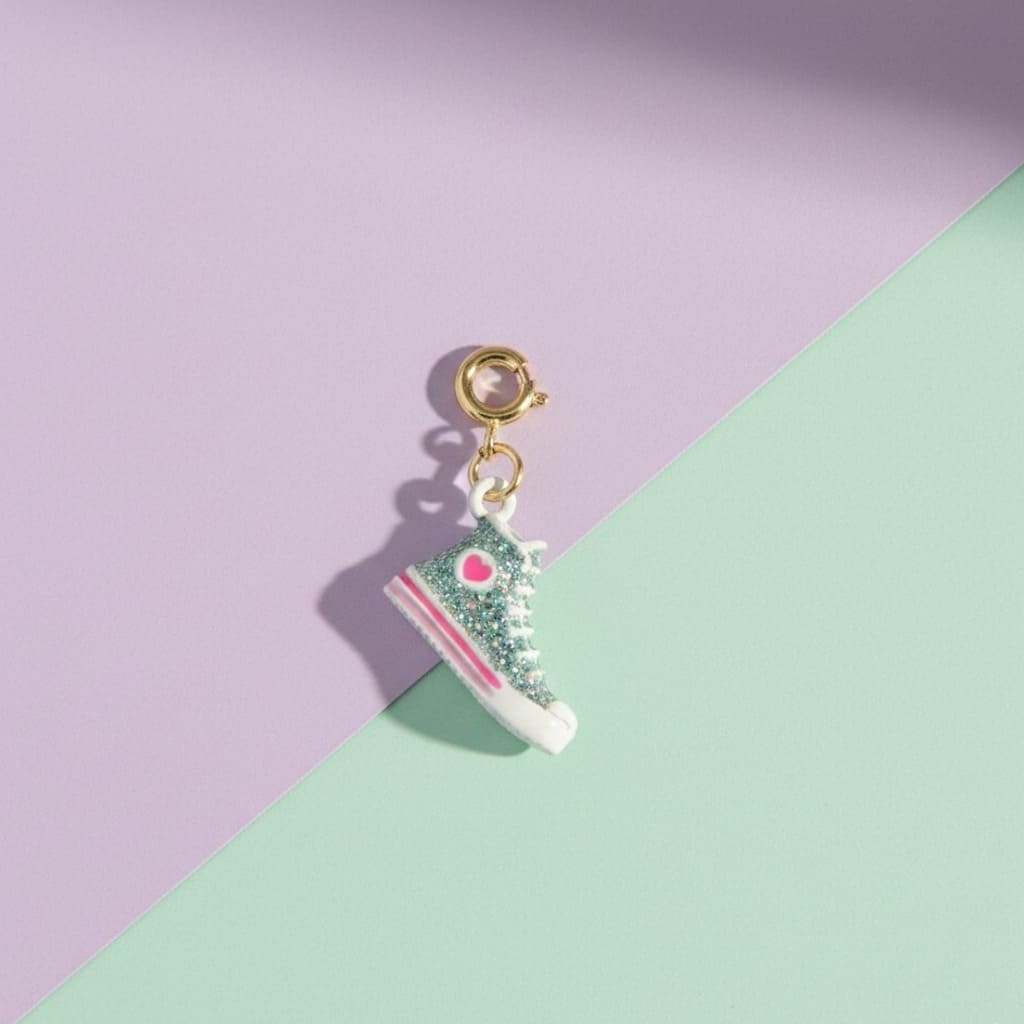 Shoe-shaped charm with glittery design on a purple and green background