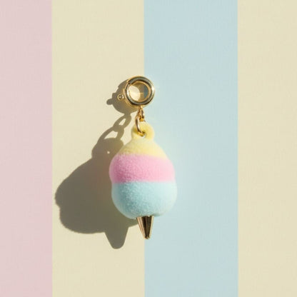 Pastel cotton candy charm on a pastel striped background