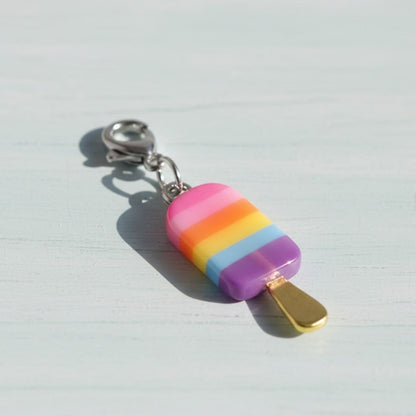 Colorful ice cream popsicle charm on a light gray background