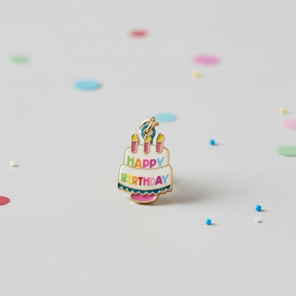 Birthday cake charm with candles and 'Happy Birthday' text on a light gray background with confetti.