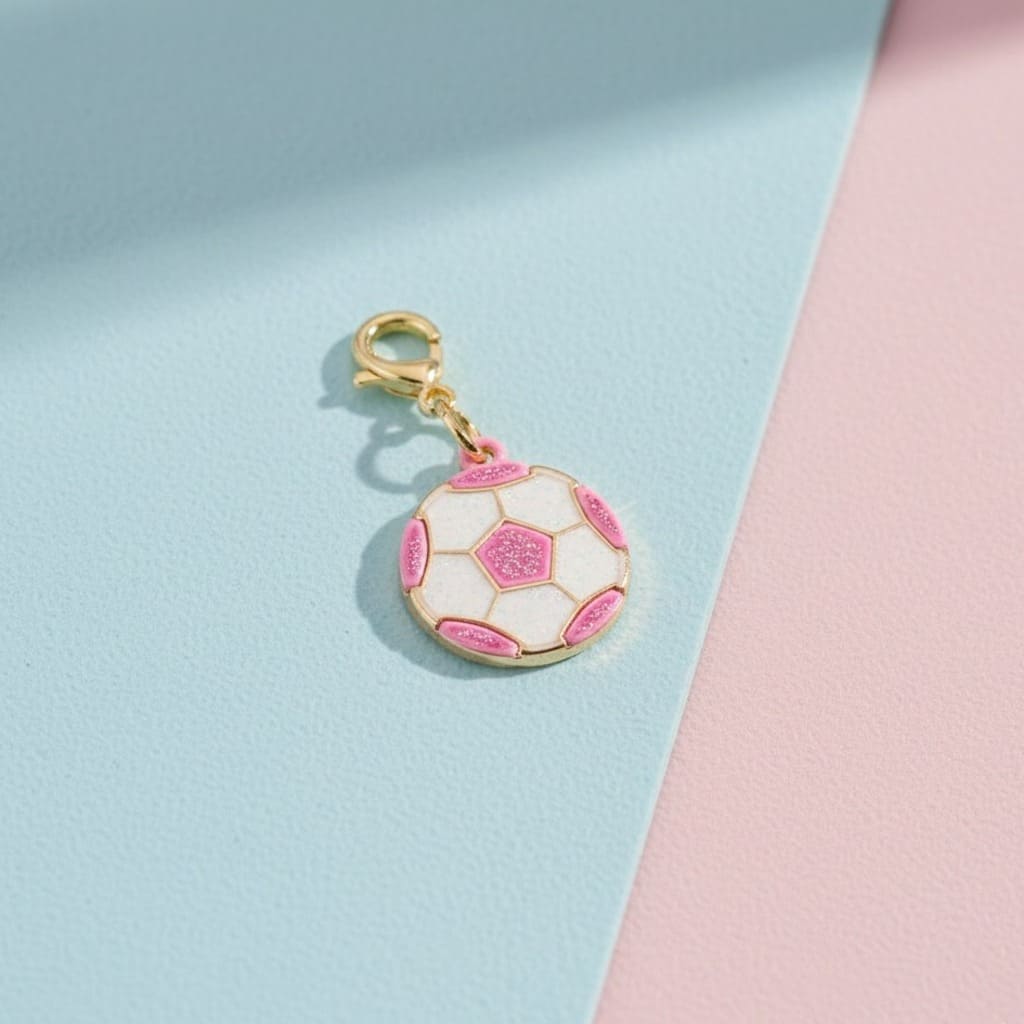 Soccer ball keychain with pink accents on a light blue and pink background