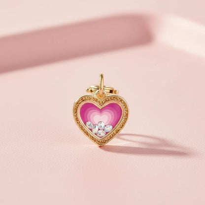 Heart-shaped pendant with pink center and gold frame on a pink background
