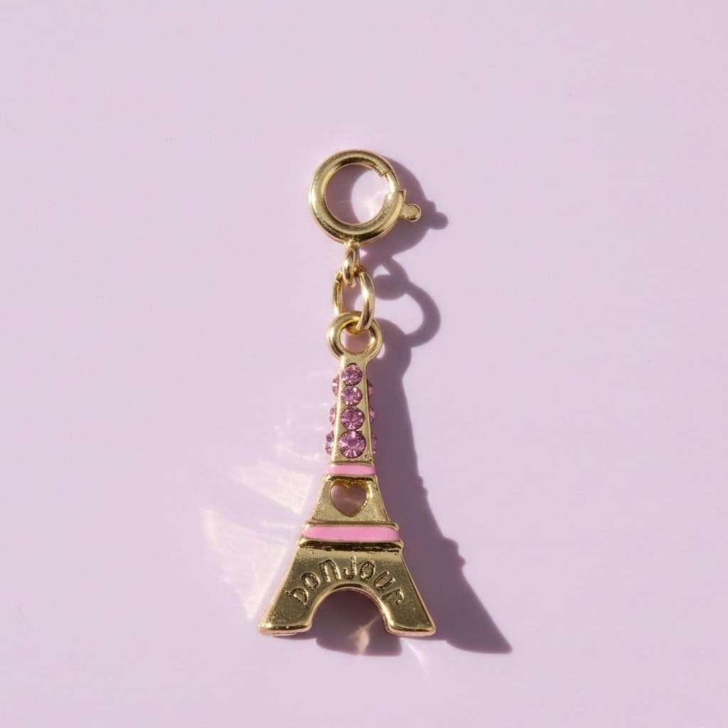 Eiffel Tower charm with pink accents on a light purple background