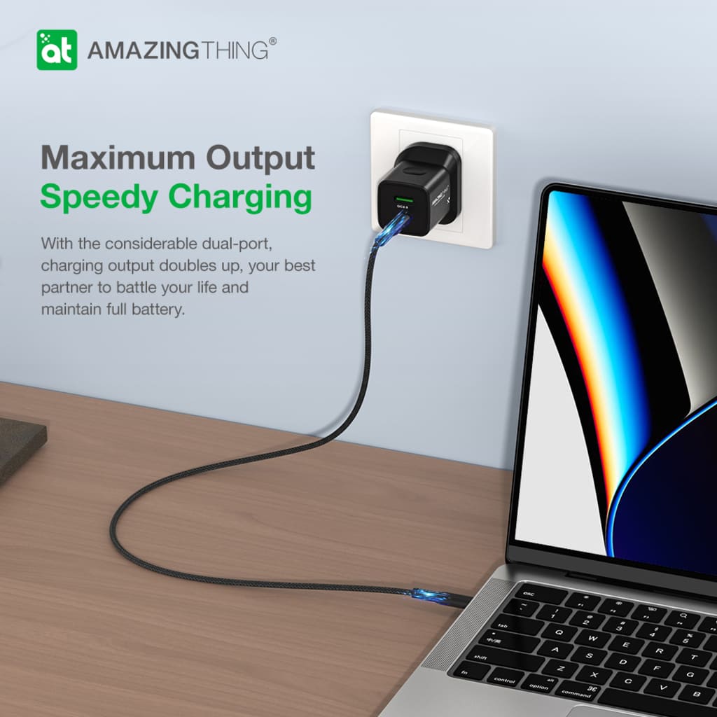 Laptop being charged by a dual-port charger with 'Amazing Thing' branding.