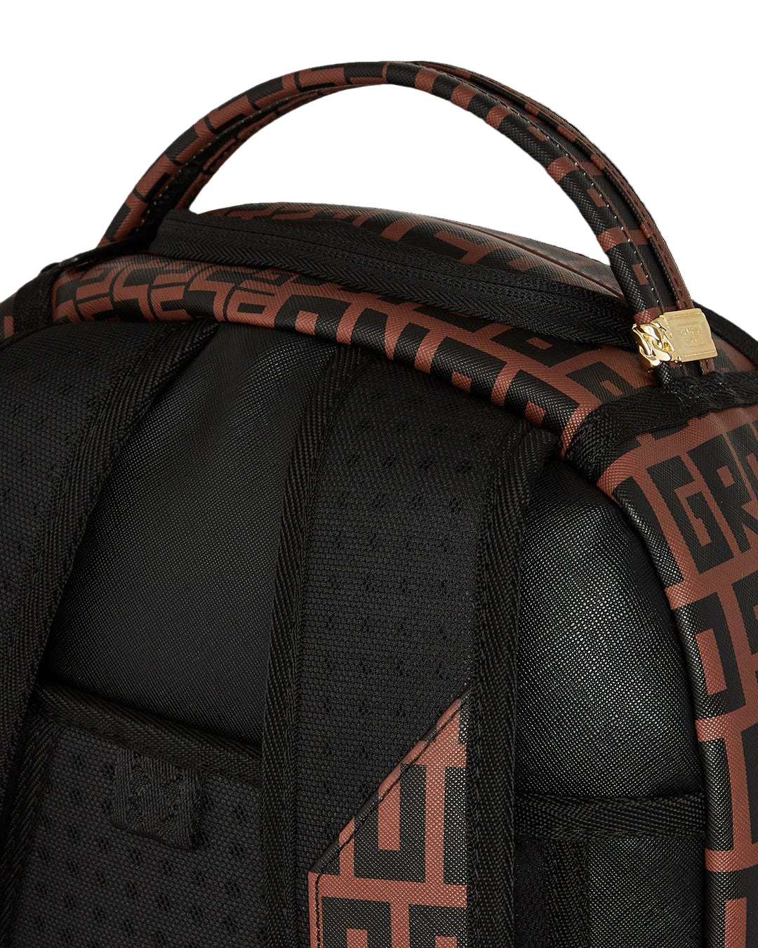 Black backpack with brown patterned straps on a black background