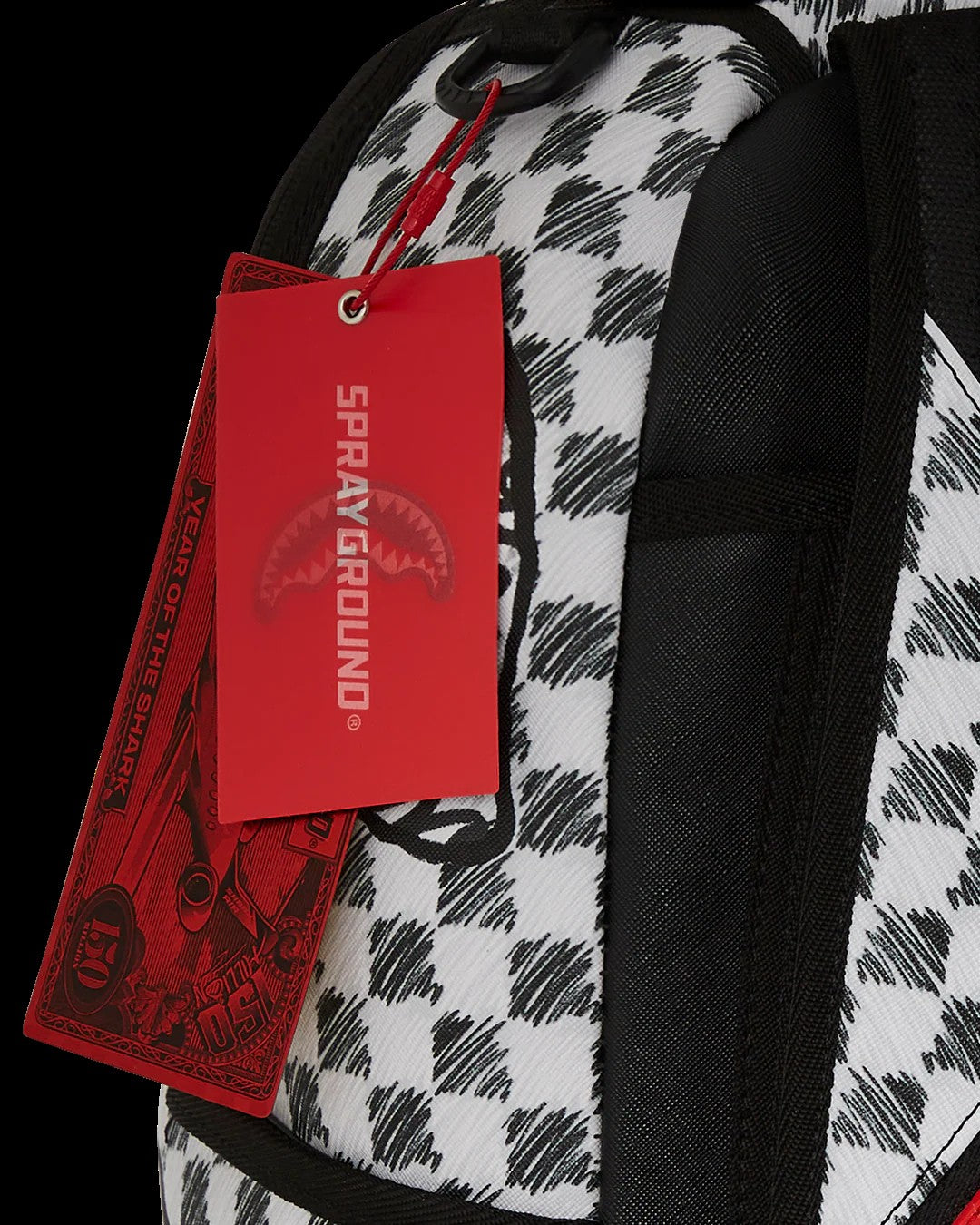 Backpack with a red Sprayground tag on a black background