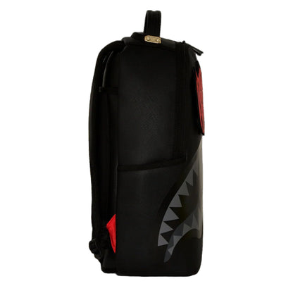 Black backpack with shark mouth design on a black background