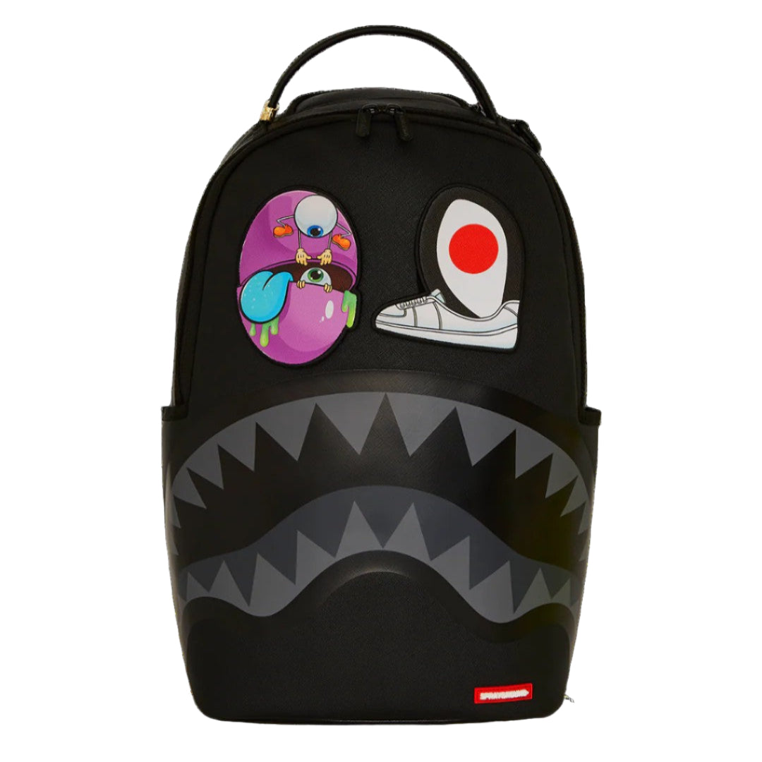 Black backpack with cartoon character patches on a black background