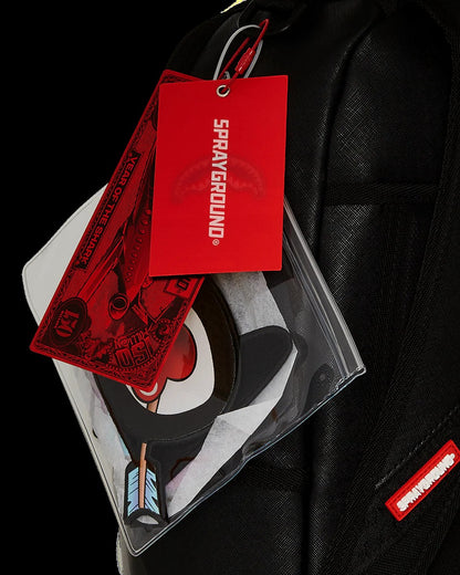 Sprayground product with red tag and clear packaging on a black background