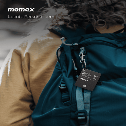 Person wearing a teal backpack with a Momax tag, focusing on locating personal items.