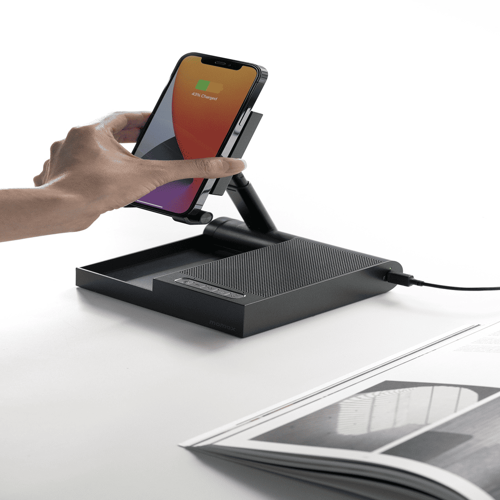 Hand using a smartphone on a black document camera with a white background