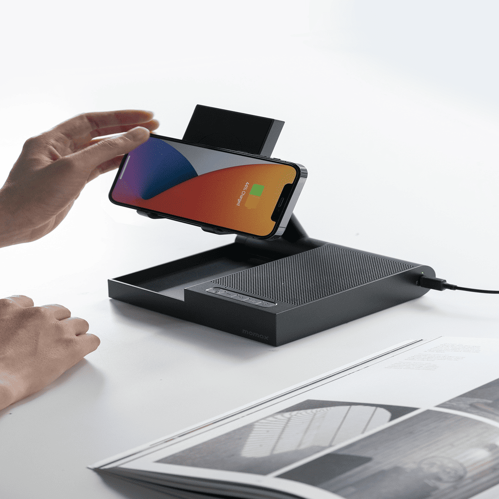 Person using a smartphone with a screen protector on a black stand against a white background