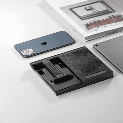 Black phone stand with smartphone and tablet on a white surface