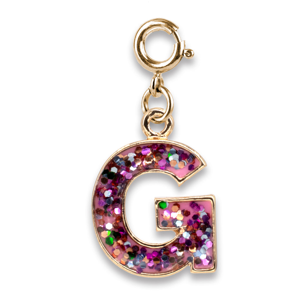 Gold charm with a glittery letter 'G' on a white background