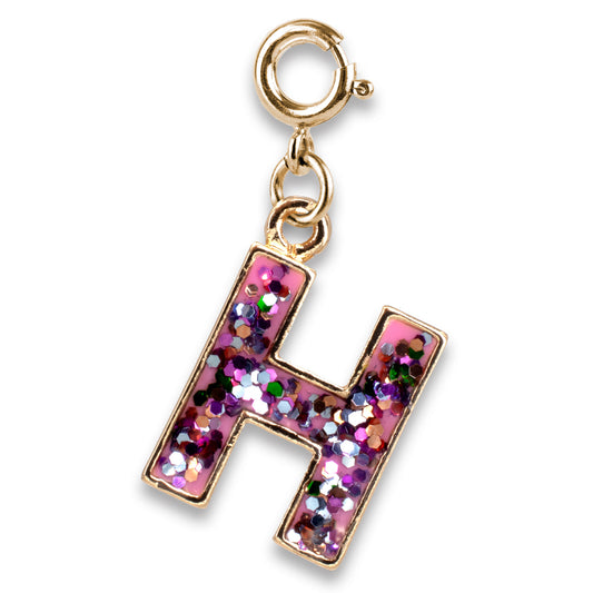 Gold charm with a pink letter 'H' filled with glitter on a white background