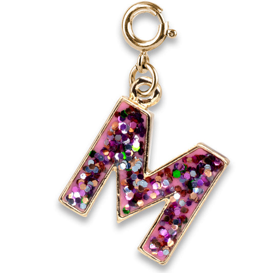 Gold charm with a pink glittery letter 'M' on a white background