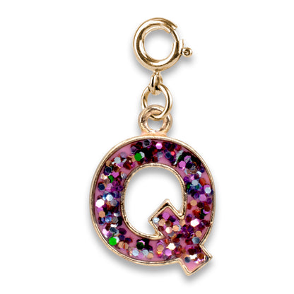 Gold charm with a multicolored glittery letter 'Q' on a white background