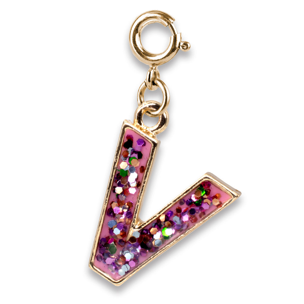 Gold charm with a pink letter 'V' filled with glitter on a white background