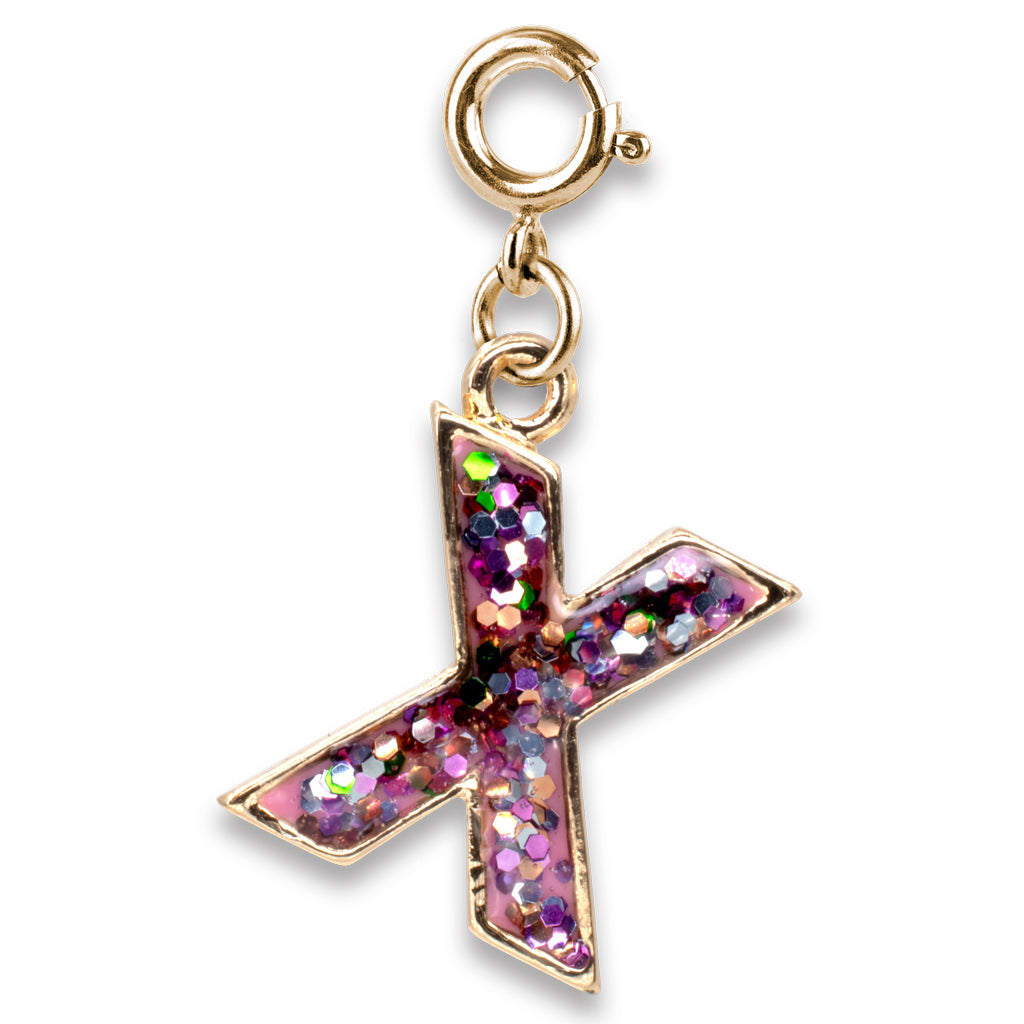 Gold charm with a pink, glittery cross on a white background
