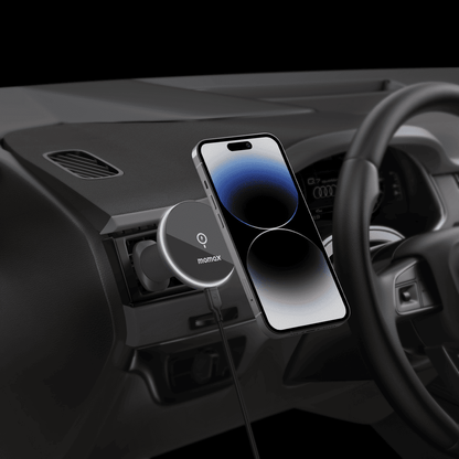 Wireless phone charger in a car dashboard with a smartphone on top