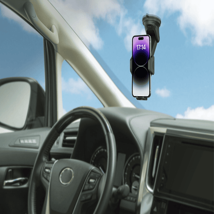 Car phone holder with smartphone displaying time inside a vehicle with a blue sky background