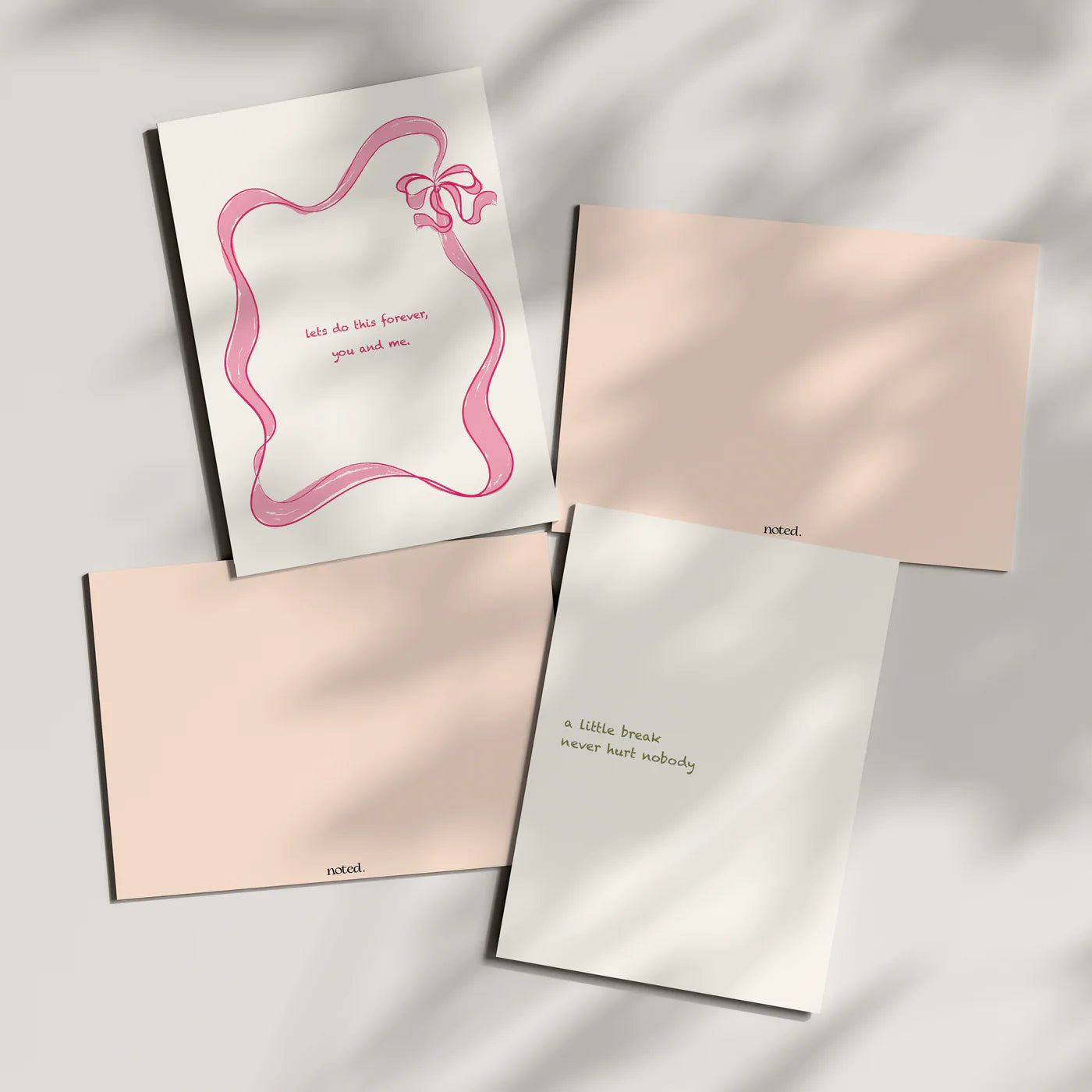 Set of four greeting cards with different designs on a light background