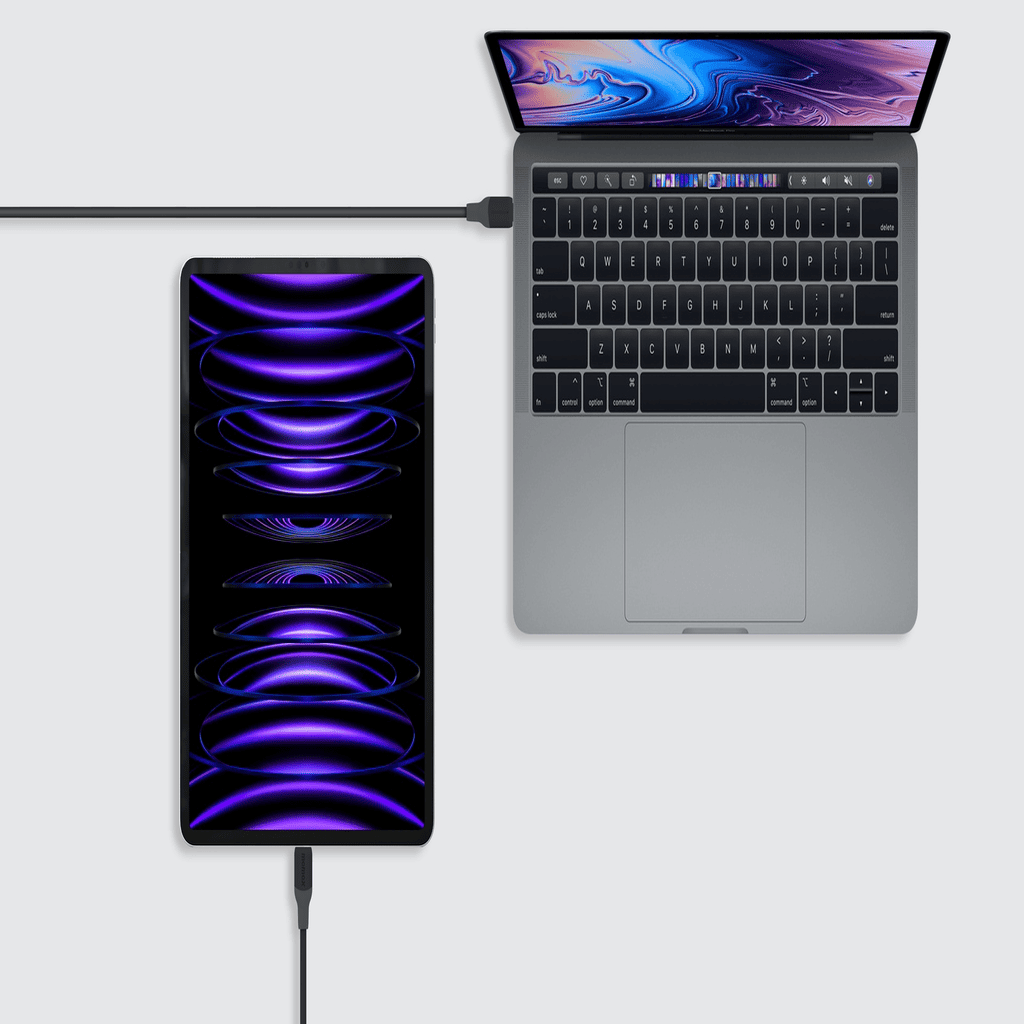 Laptop connected to a portable display on a white background