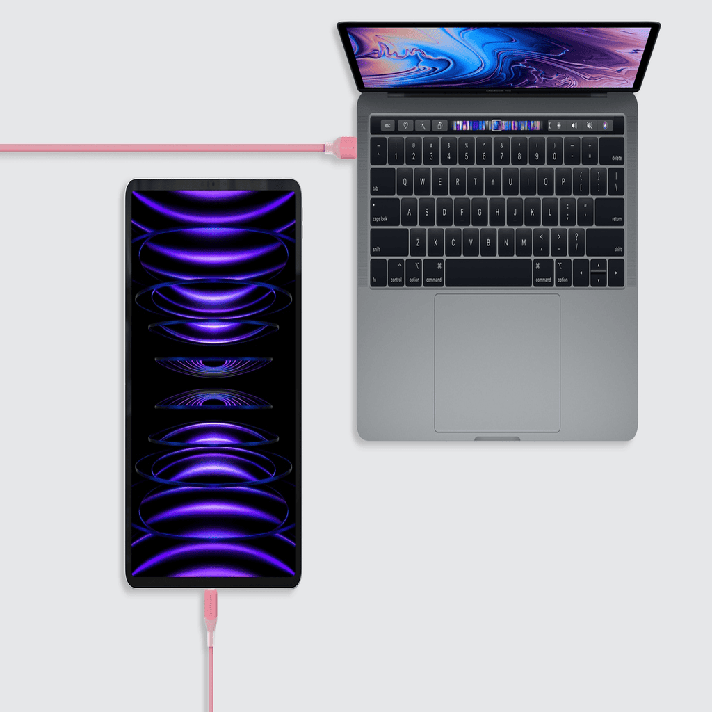 Laptop and smartphone with a purple and blue display on a white background