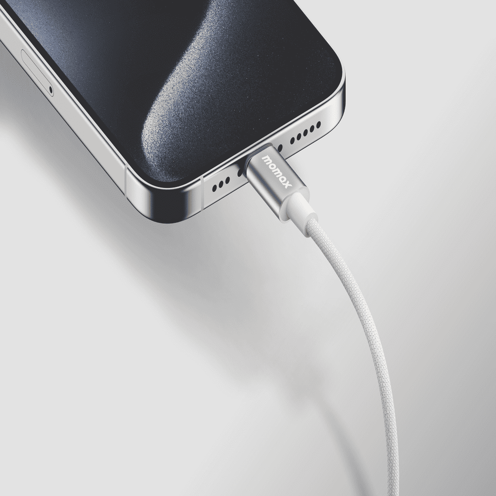 Smartphone being charged with a cable on a light gray background