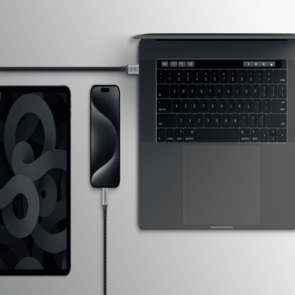 Laptop, smartphone, and tablet on a light gray surface