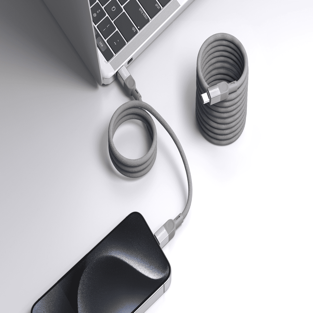 Laptop and phone with coiled cables on a light gray surface