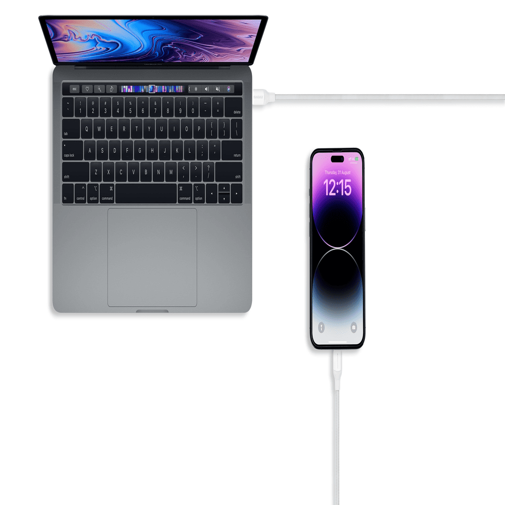 Laptop and smartphone connected by a cable on a white background