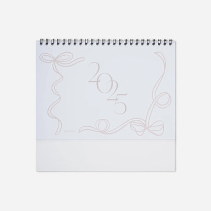 White spiral-bound notebook with decorative design and '2025' on a white background