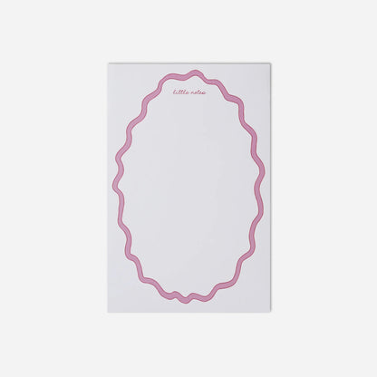Notepad with pink decorative border on a white background