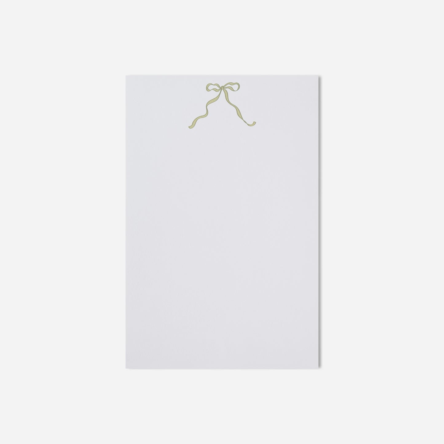 White paper with a gold bow on a white background
