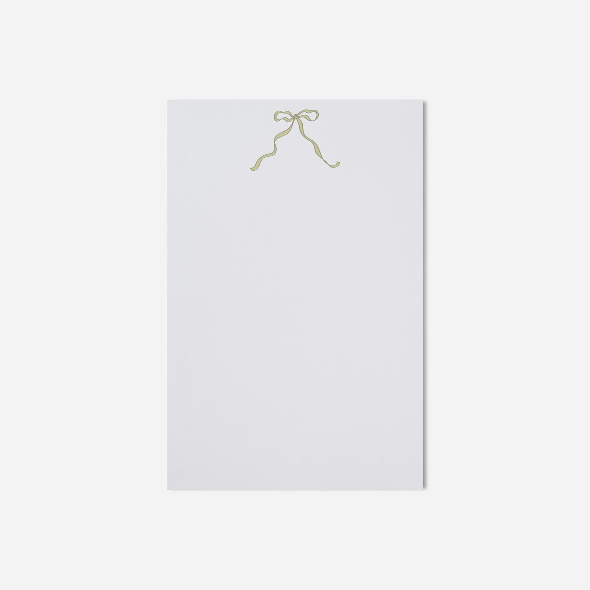 White paper with a gold bow on a white background